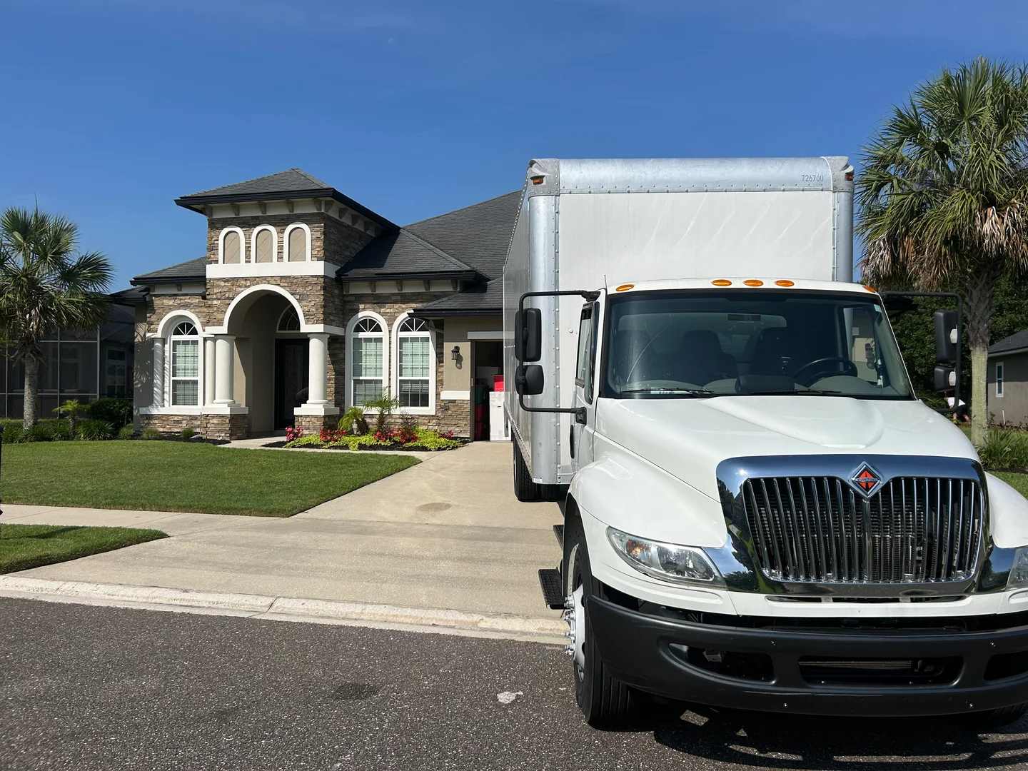 Happy 2 Help Moving truck parked at a Northeast Florida customer's home